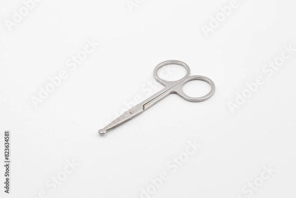 Fototapeta Silver metal scissors on a white background, Scissors for sewing on white background, Very sharp retro professional tailor scissors
