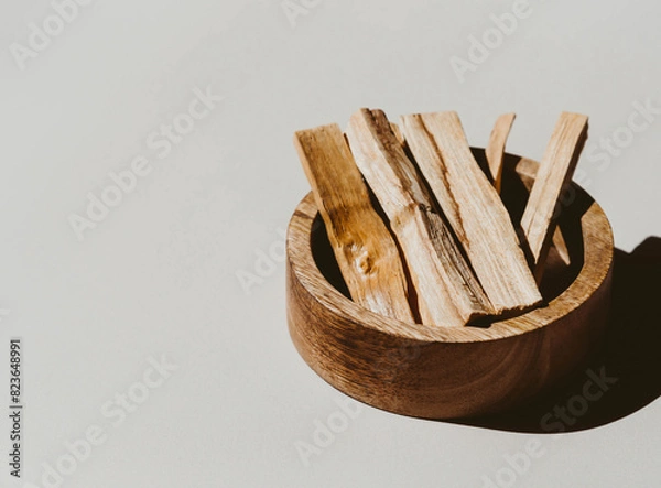 Fototapeta Palo Santo sticks in wood box on a light background. A set of incense for fumigation.