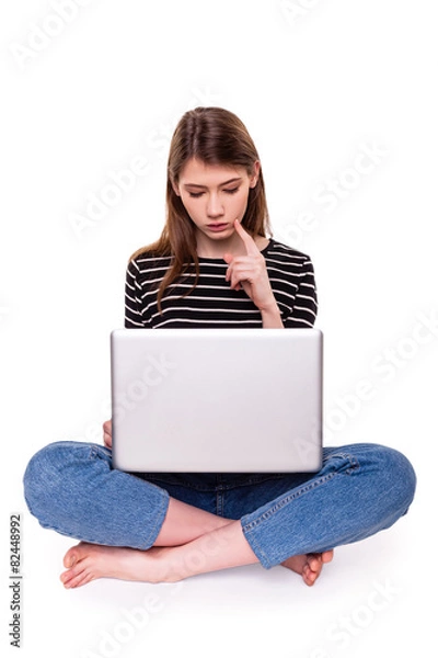 Obraz Young Woman with PC hand on chin E-commerce Stock Image