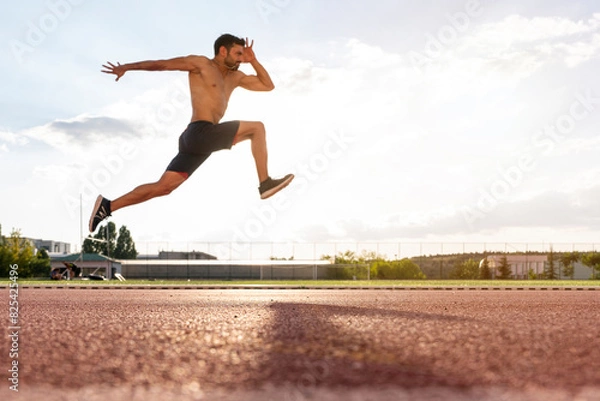 Fototapeta An athlete who long jumps and jumps high