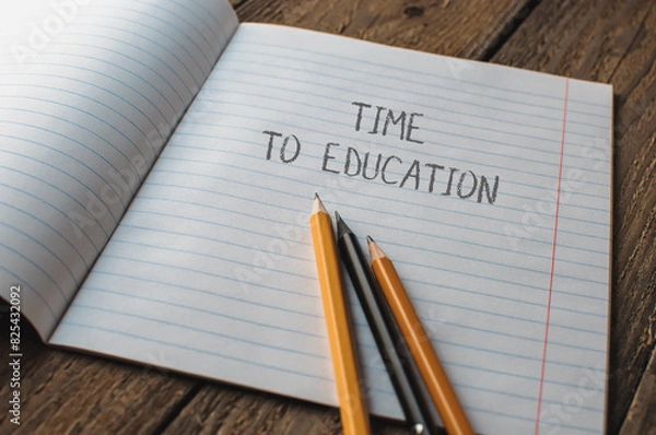 Fototapeta A notebook with pencils on it and the words time to education written on it