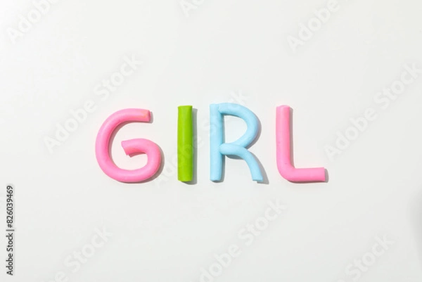Fototapeta The word "girl" is made of colored plasticine on a white background.