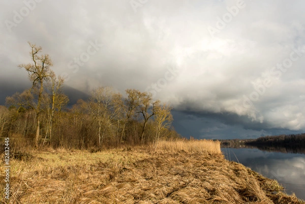 Obraz dramatic clouds over the river