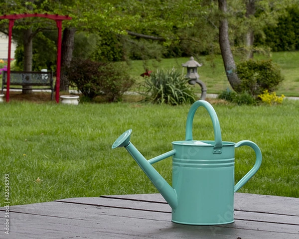 Fototapeta Tourquoise watering can next to gardens