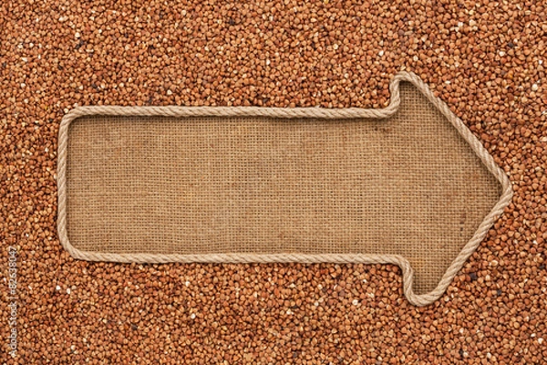 Obraz Pointer made from rope with grain buckwheat  lying on sackcloth
