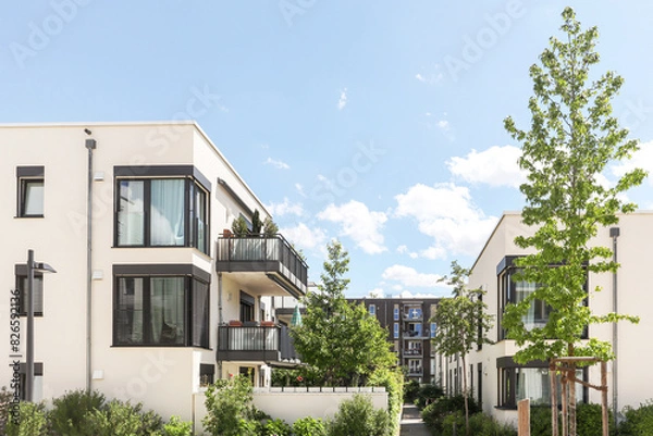 Obraz Residential area with ecological and sustainable green residential buildings, low-energy houses with apartments and green courtyard