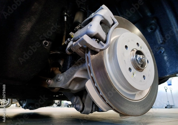 Fototapeta The brake disc and brake caliper are installed on the vehicle.
