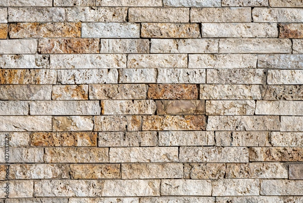Fototapeta Background from a wall of beige and brown clinker bricks