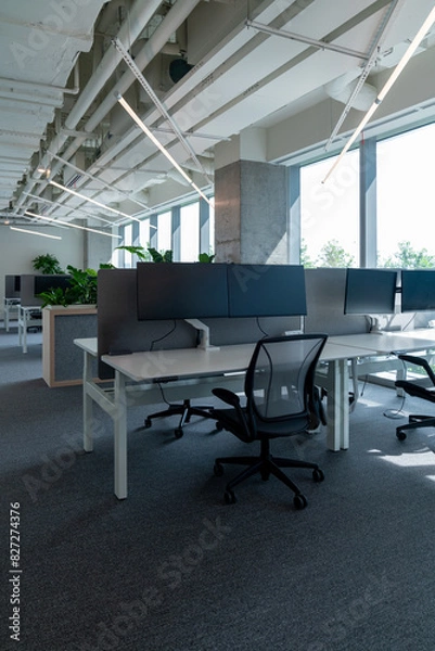 Fototapeta Interior of modern empty office building.Open ceiling design.Equipped with automatic lifting table and LCD screen.