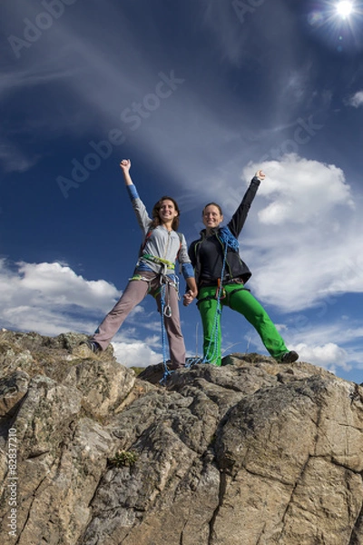 Obraz Group of two happy female climbers  celebrates victory