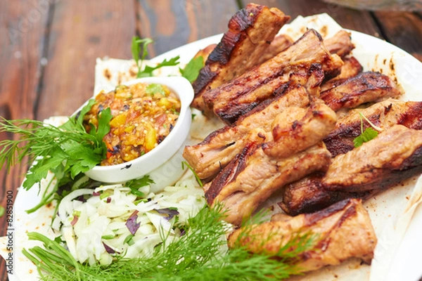 Fototapeta grilled ribs on fire with vegetables