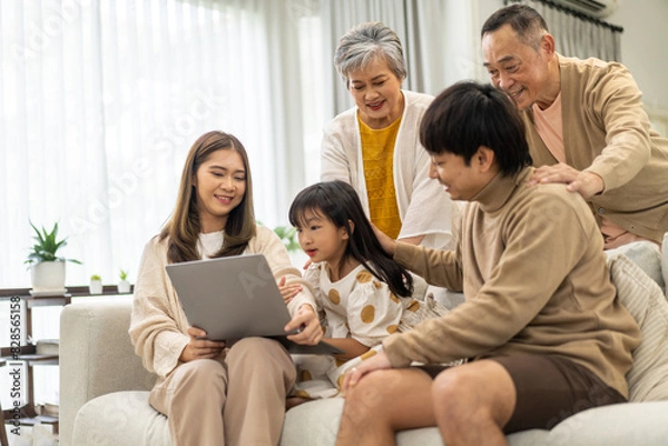 Fototapeta Father and mother with asian kid girl learn on laptop computer reviewing lesson study with online education e-learning.student look for educational knowledge in homeschool at home.Education
