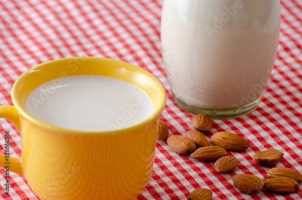 Obraz Almond milk in a glass, highlighting its creamy texture and health benefits.