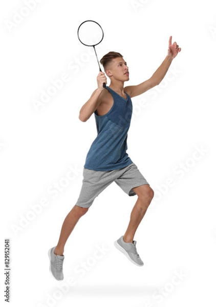 Fototapeta Young man playing badminton with racket on white background