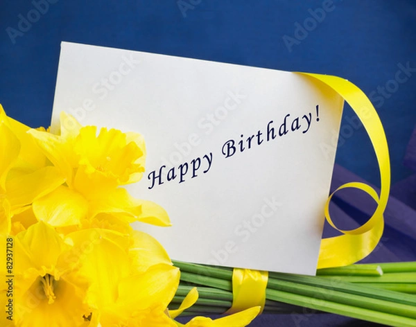 Fototapeta Bucket of narcissus flowers, envelope on blue-purple background