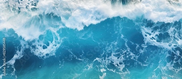 Fototapeta An impressive aerial photo showing ocean waves crashing in deep waters ideal for backgrounds A drone s bird s eye perspective captures the dynamic seascape in this captivating copy space image