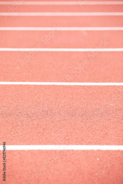 Fototapeta Vertical shot of a track with red and white markings and stripes
