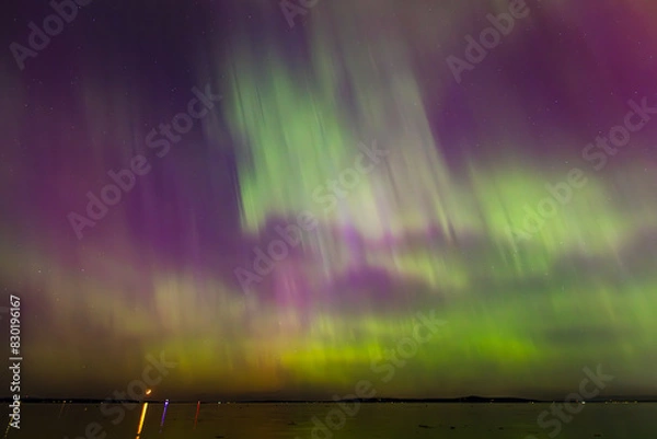 Fototapeta Night time skies light up in vibrant colors thanks to the Northern Lights over Washington state