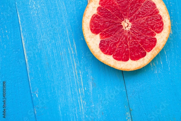 Fototapeta grapefruit on the blue table