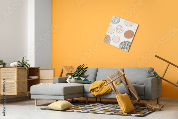 Fototapeta Interior of living room with messed furniture after strong earthquake