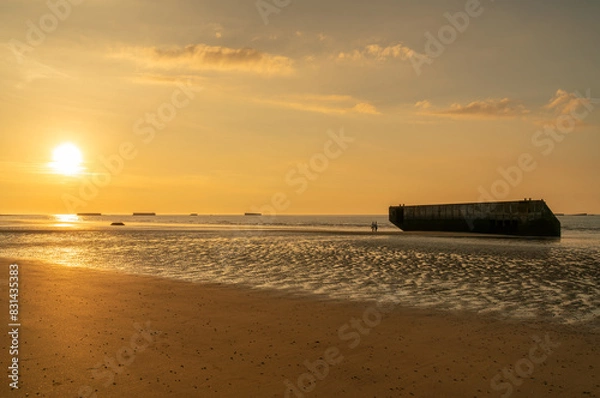Fototapeta Remains of the D-Day Mulberry Harbour on the Beach at Arromanches Les Bains, Normandy, France