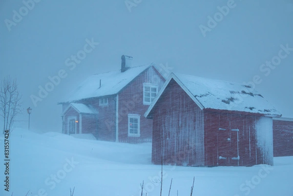 Fototapeta Swedish red houses in one of the strongest snowstorms of 2024, Hemavan, Sweden