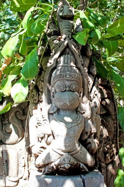 Fototapeta Appreciate the intricate stone carving set within the lush greenery of its surroundings