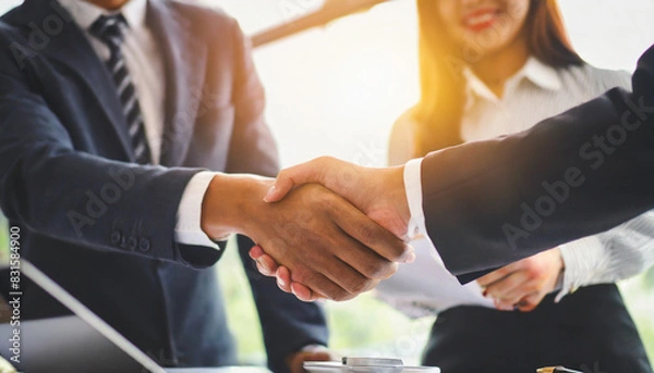 Fototapeta businessmen shaking hands in agreement, symbolizing successful partnership and teamwork