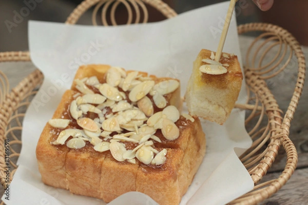 Obraz Toast topped with almonds and honey.