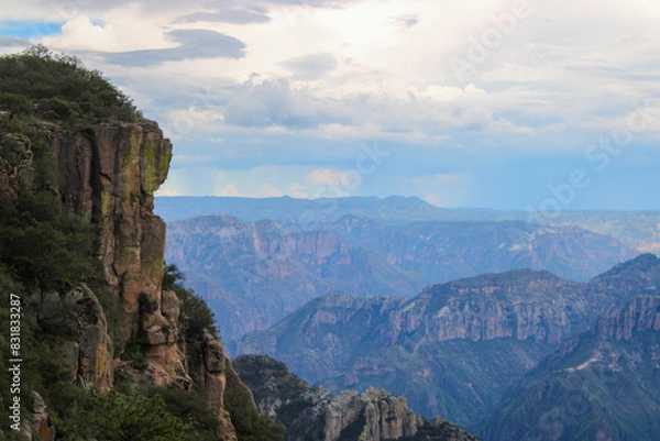 Fototapeta Landscape of impressive mountains in the background with clouds and rain in the background