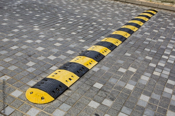 Obraz Traffic safety speed bump on an asphalt road