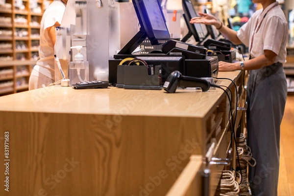 Fototapeta Selective focus to edge of POS machine with blurry cashier staff receive orders from customers at counter service in restaurant or cafe or department store.