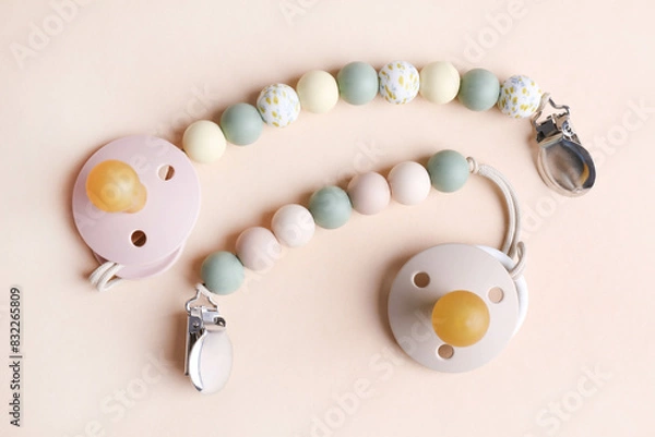Obraz Two pacifiers with clip