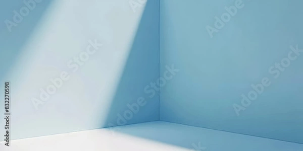 Fototapeta Minimalist room with sunlight streaming through, creating a clean and serene atmosphere with soft blue tones and simple elegance
