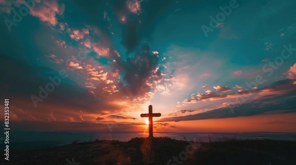 Fototapeta Solitary cross with a vibrant sunset sky as the backdrop, evoking tranquility and reflection