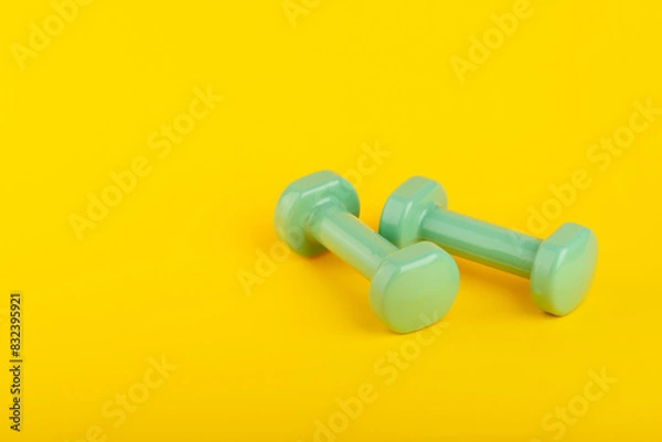 Fototapeta Gym equipment on yellow background. Space for text