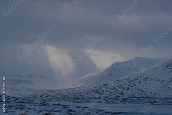 Obraz Blue sky peeking through dark storm clouds