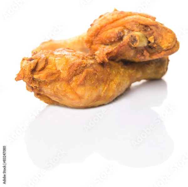 Obraz Deep fried chicken drumsticks over white background
