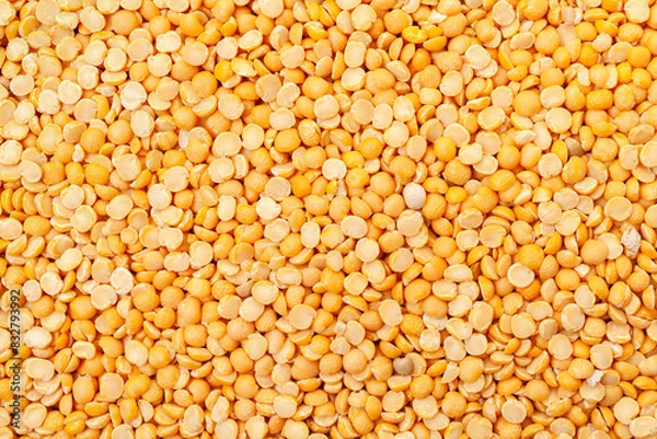 Fototapeta Uncooked, split, yellow peas background. Dry peas grains. Top view