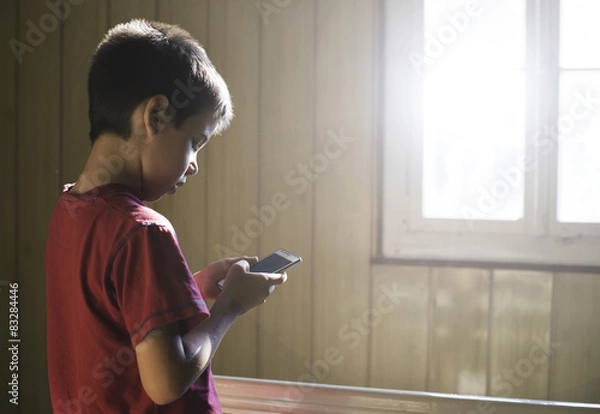 Fototapeta Child playing with phone