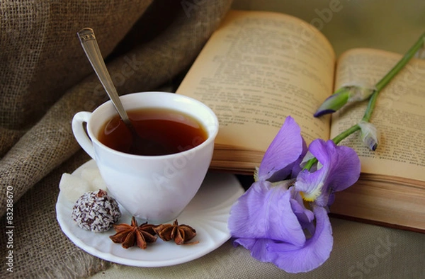 Obraz Cup of tea, open book and flower iris.