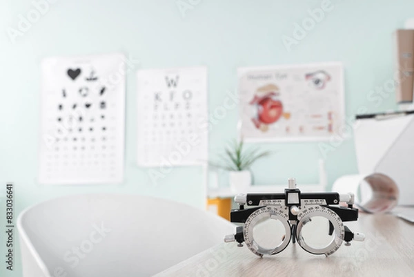 Fototapeta Trial frame on table at ophthalmologist's office, closeup