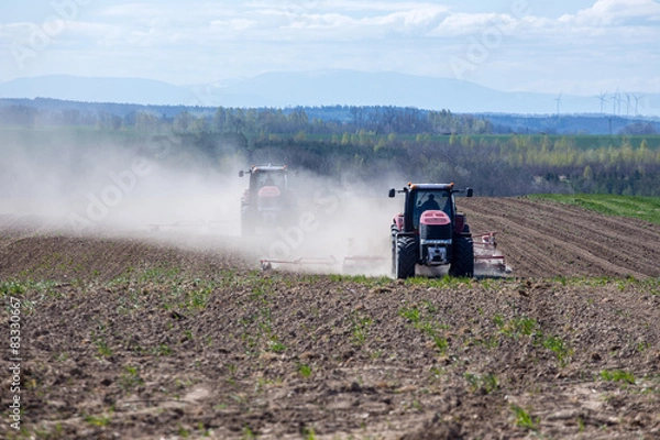Obraz Tractor harrowing the field