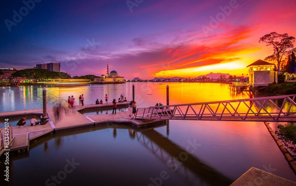 Fototapeta the view of the river and the pier in the red twilight