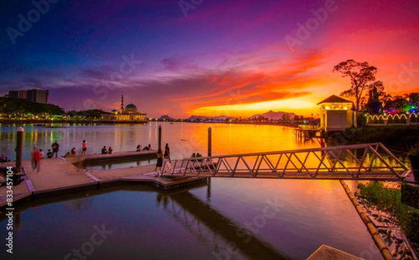 Fototapeta the view of the river and the pier in the red twilight
