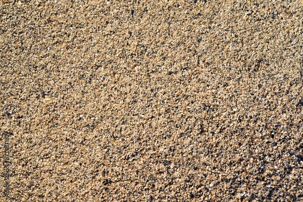 Obraz The river sand is coarse-grained. Small pebbles of river sand. Macrophotography of sand.