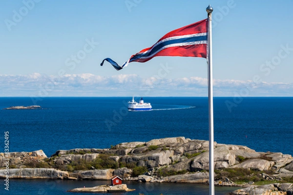 Fototapeta Norwegian flag with a small red cabin and an unmarked ferry