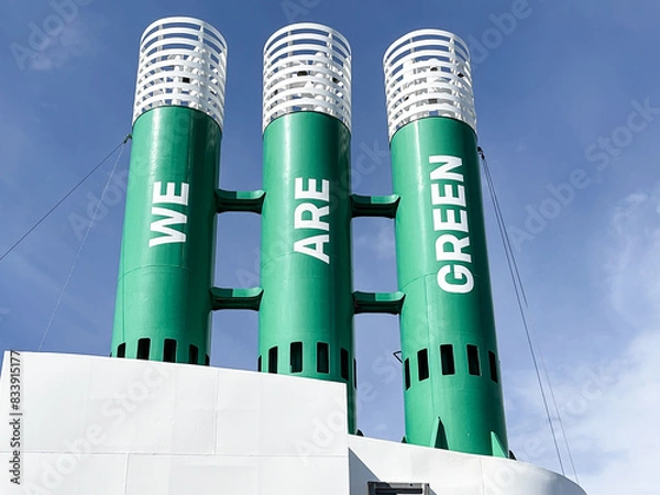 Fototapeta Three ferry funnel chimneys with the slogan we are green on green painted chimneys indicating the use of natural gas in place of deisel oil
