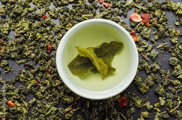 Obraz bowls with leaf green oolong tea and strawberries