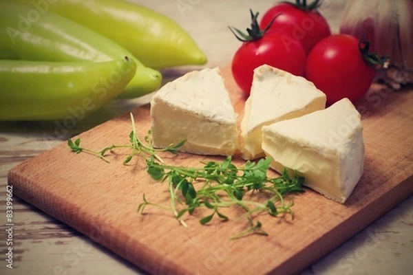 Fototapeta Vintage retro photo of three camembert portions